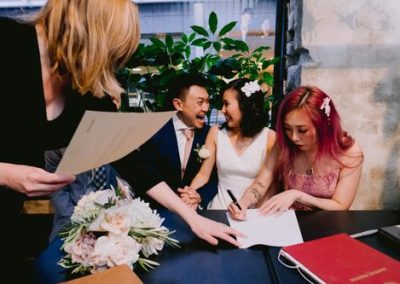 63079ac6802925a4ae6d25ad_bride-and-groom-laughing-at-each-other-during-signing-of-register-at-Chancery-Lane-Bistro (1)-p-500